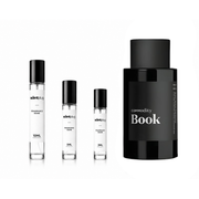 Sample of The Scent Plug Book Commodity decant in a small, clear container, showcasing the fragrance sample inside.