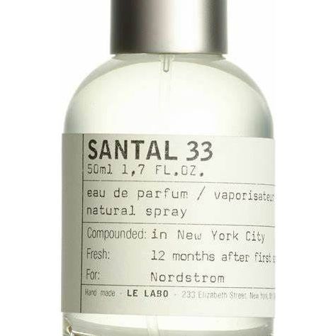 Le Labo Santal 33 Eau de Parfum spray in 3.4 oz bottle, featuring a sleek design and amber-colored liquid.