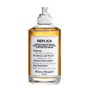 Maison Margiela Replica By The Fireplace Eau de toilette spray in 3.4 oz bottle, with warm, smoky scent and minimalist packaging.